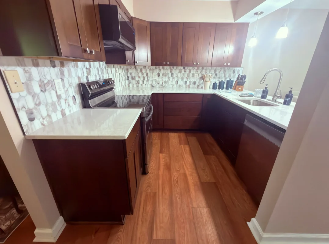 Remodeled Fort Mill kitchen with cabinets, marble countertop, marble backsplash and LVP flooring