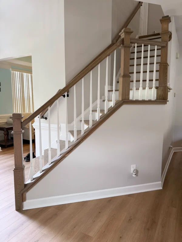 Remodeled stair railing with white balusters in Monroe